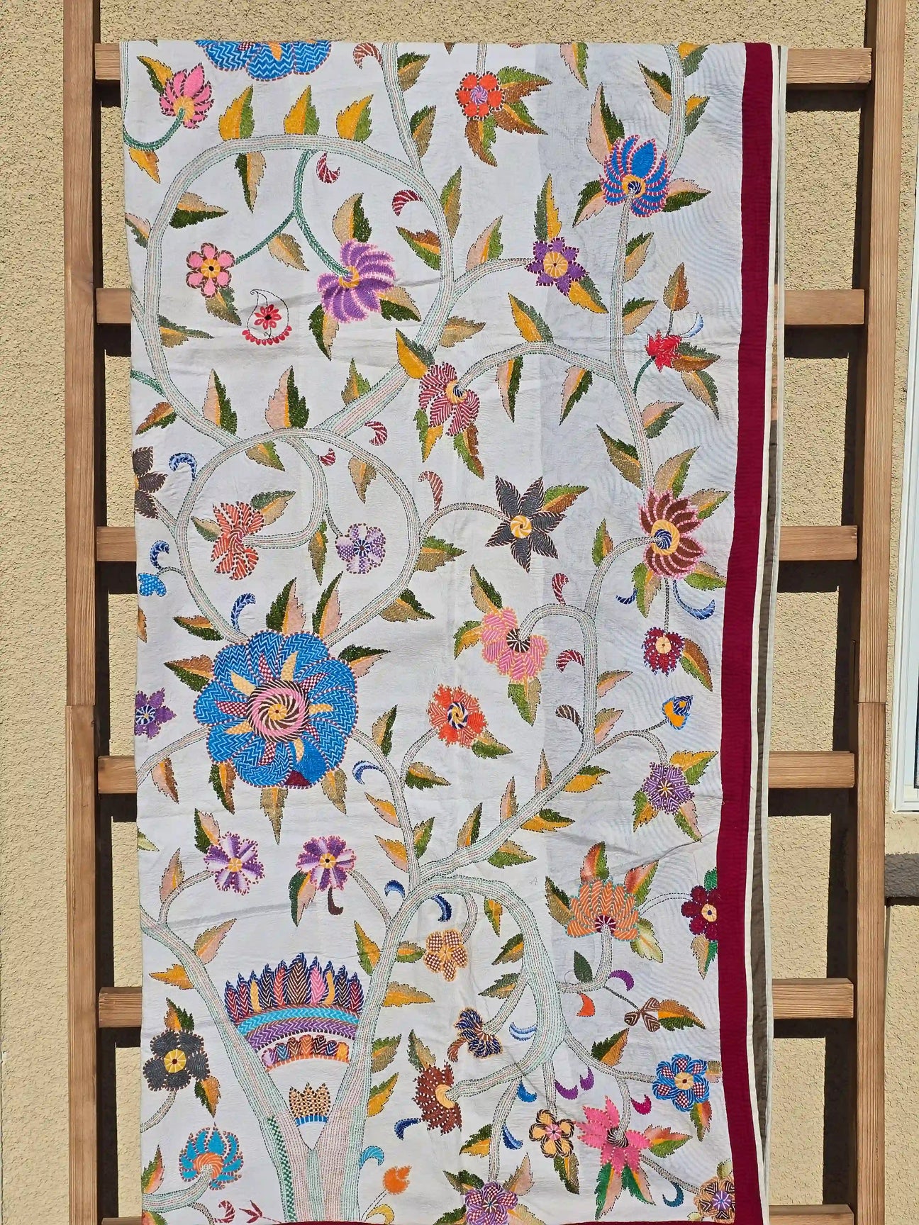 Floral Kantha quilt on display