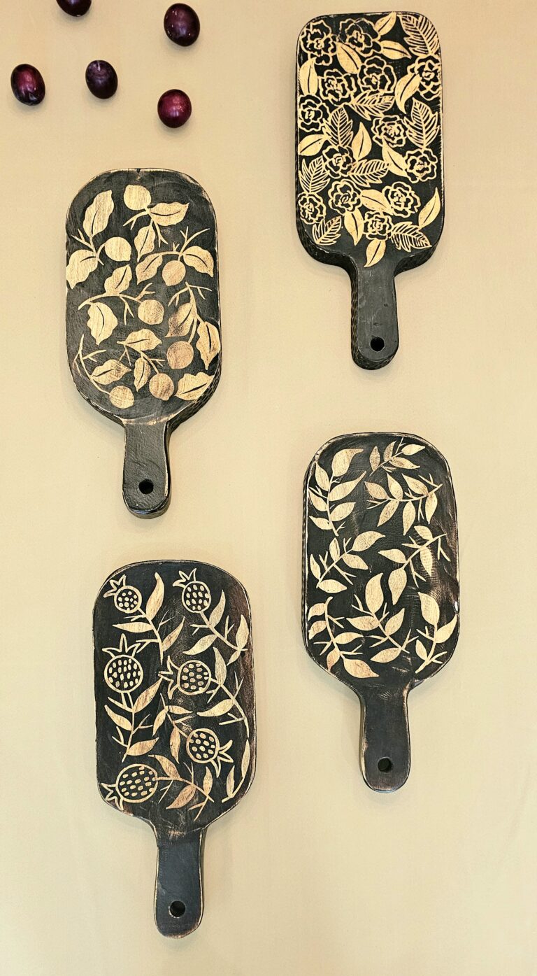 Four decorative chopping board with floral patterns on a beige background