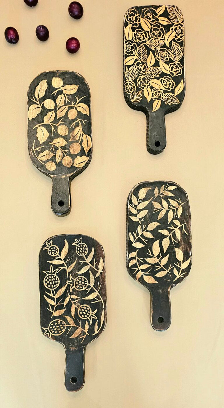 Four decorative chopping board with floral patterns on a beige background