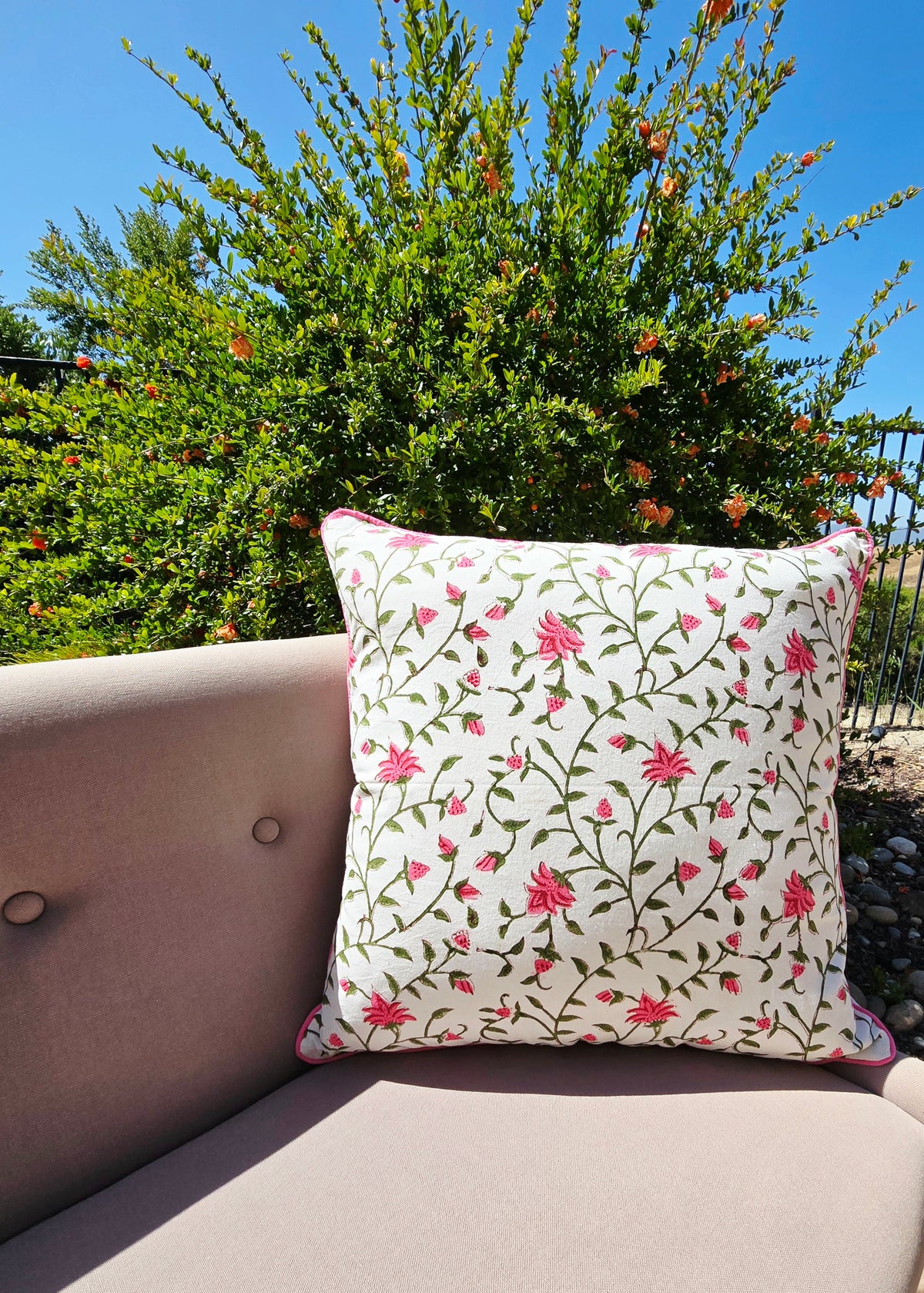 A floral printed cushion on a pillow put on a sofa