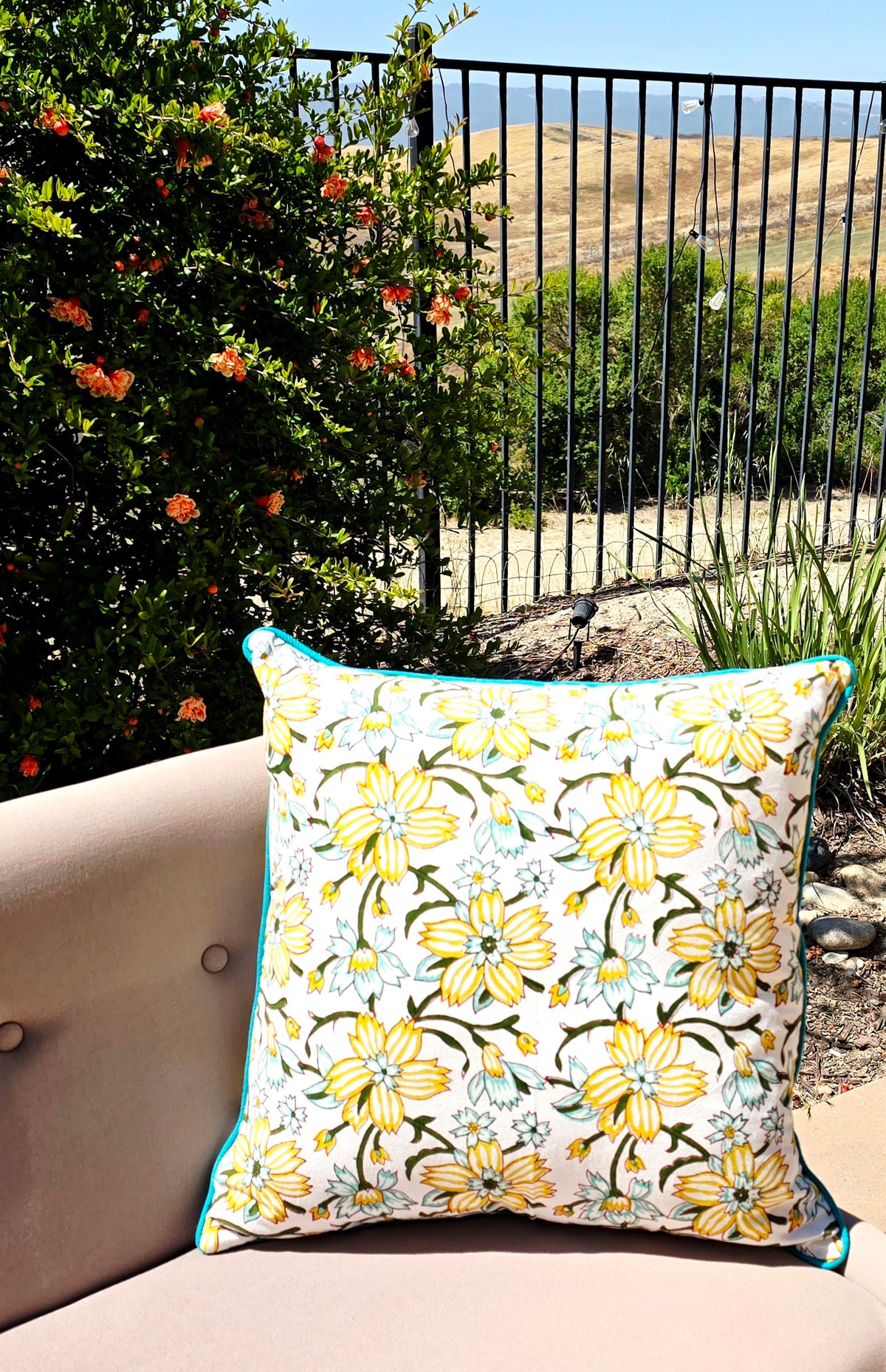 Floral printer yellow cushion cover on a cushion in outdoor background