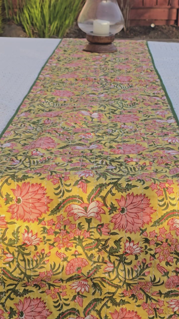 Yellow floral Kantha table runner styled on dining table for layered tablescape