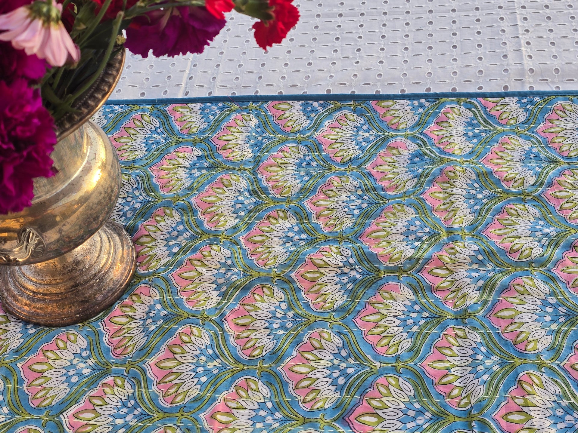 Close-up of blue floral Kantha stitching on hand block printed cotton table runner