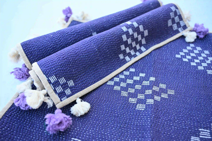 Kantha placemat set folded, showing blue color variation