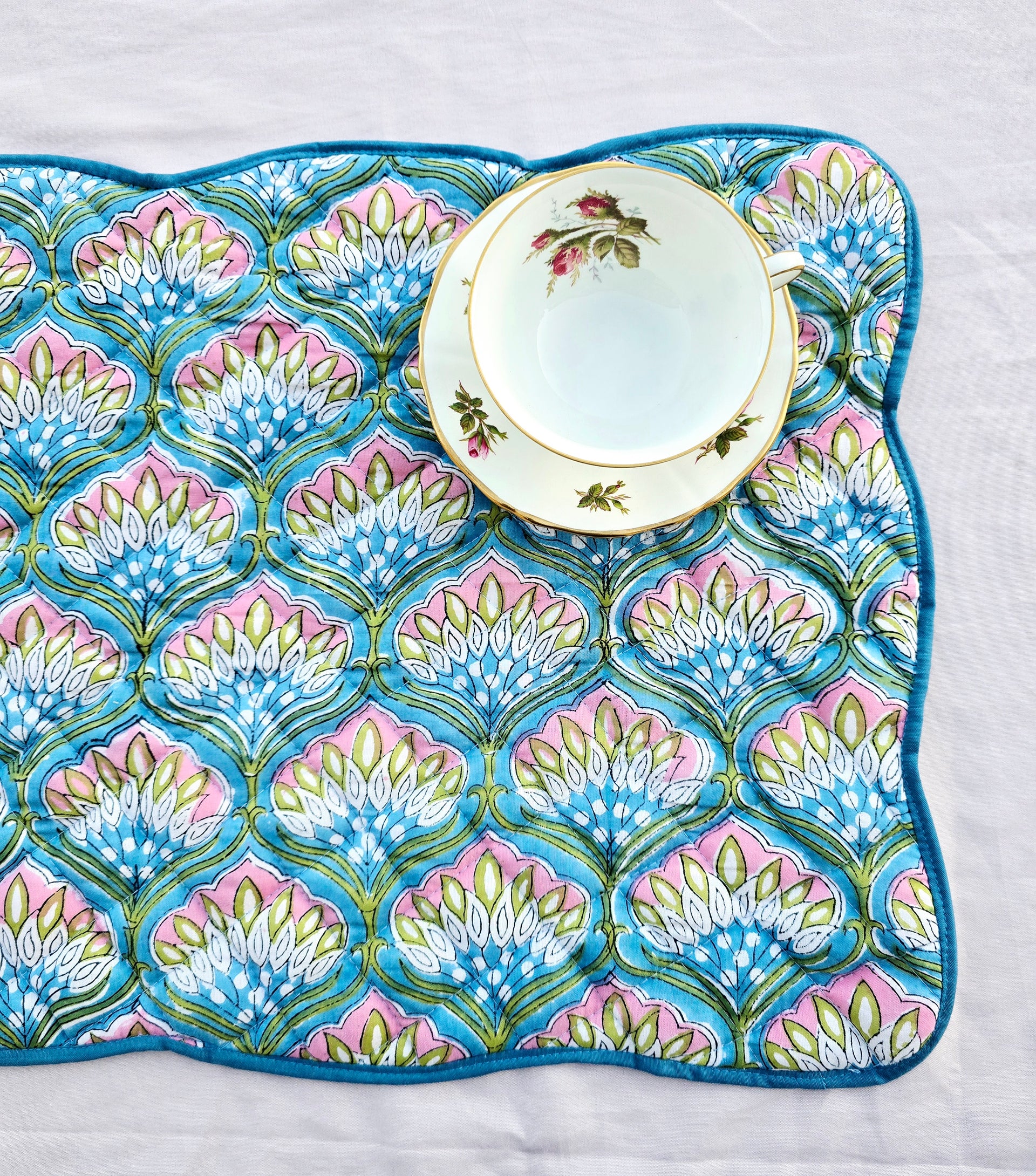 block print cotton quilted scalloped placemat on white table