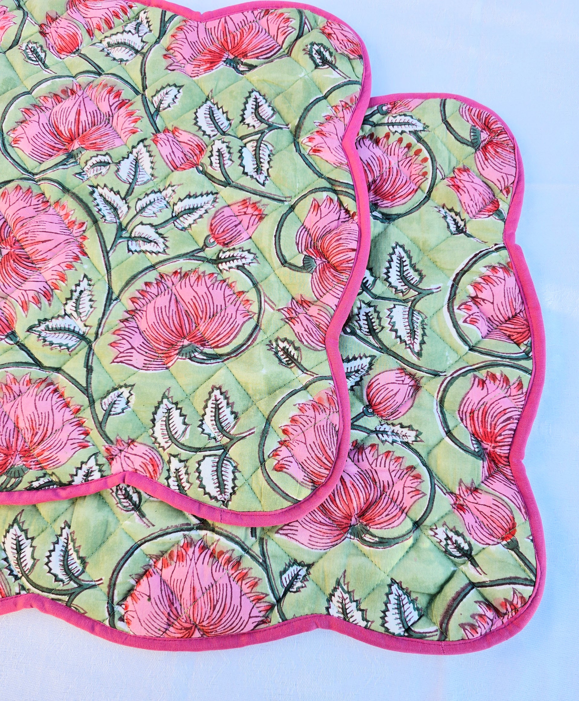 Close-up of scalloped edge on white floral cotton quilted placemat