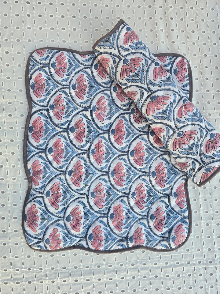 Close-up of scalloped edge on white floral cotton quilted placemat