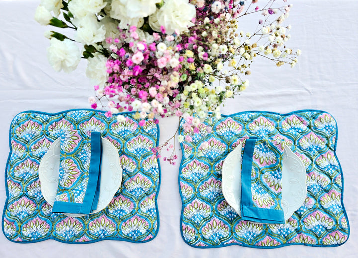 Blue Floral Cotton napkin with blue borders on a white background with flowers.