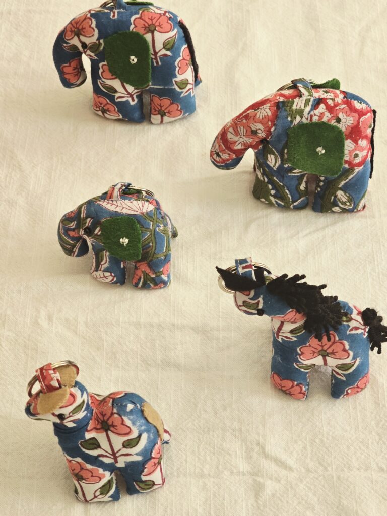 Handcrafted soft toys made from upcycled, naturally dyed cotton fabrics in earthy tones, highlighting sustainable reuse of textile remnants.