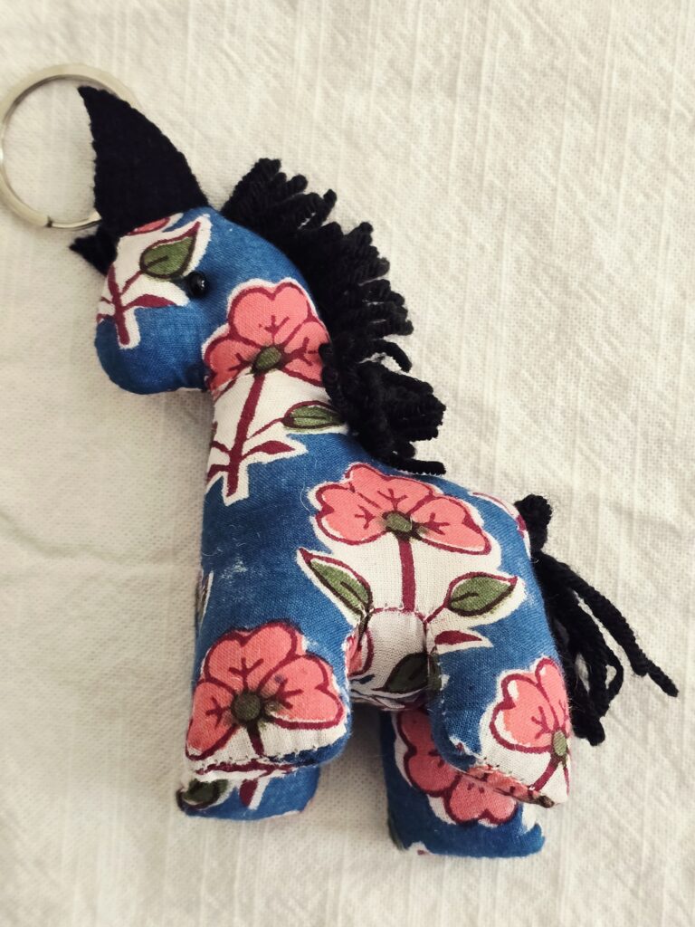 Handcrafted soft toys made from upcycled, naturally dyed cotton fabrics in earthy tones, highlighting sustainable reuse of textile remnants.